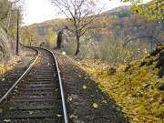 Barevná podzimní atmosféra na železniční trati u zastávky Petrov u Prahy. Snímek zachycuje trať dne 22. října 2010.